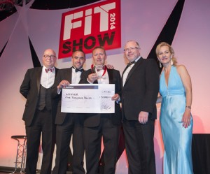 FIT Show Managing Director Paul Godwin and Fensa Chairman Mark Warren present Paul Casbolt and Karl Kinsey with their Master Fitter Challenge winners award and cheque.